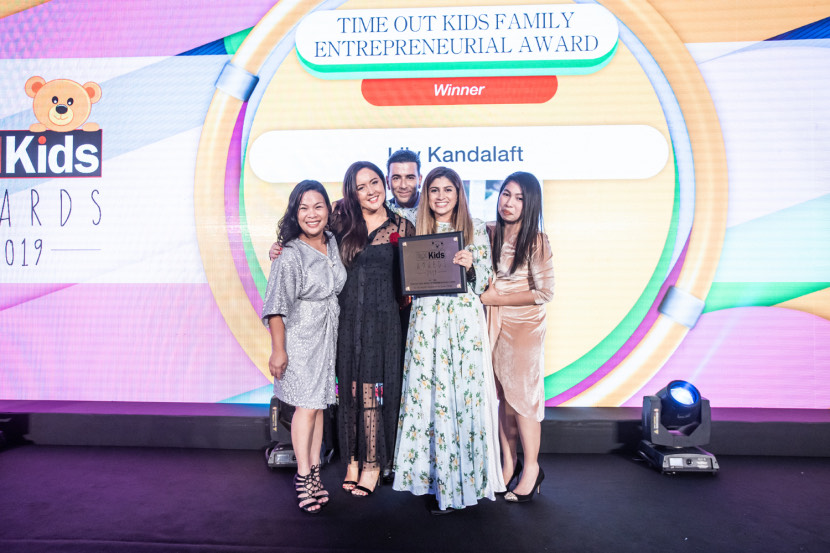 an image of people taking a photo together after receiving an award