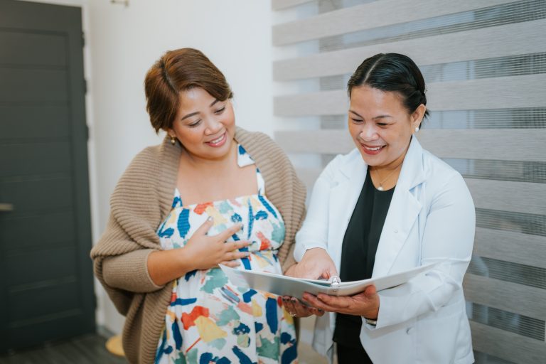 An image of a mom receiving tips and teaching from lactation consultant about breastfeeding