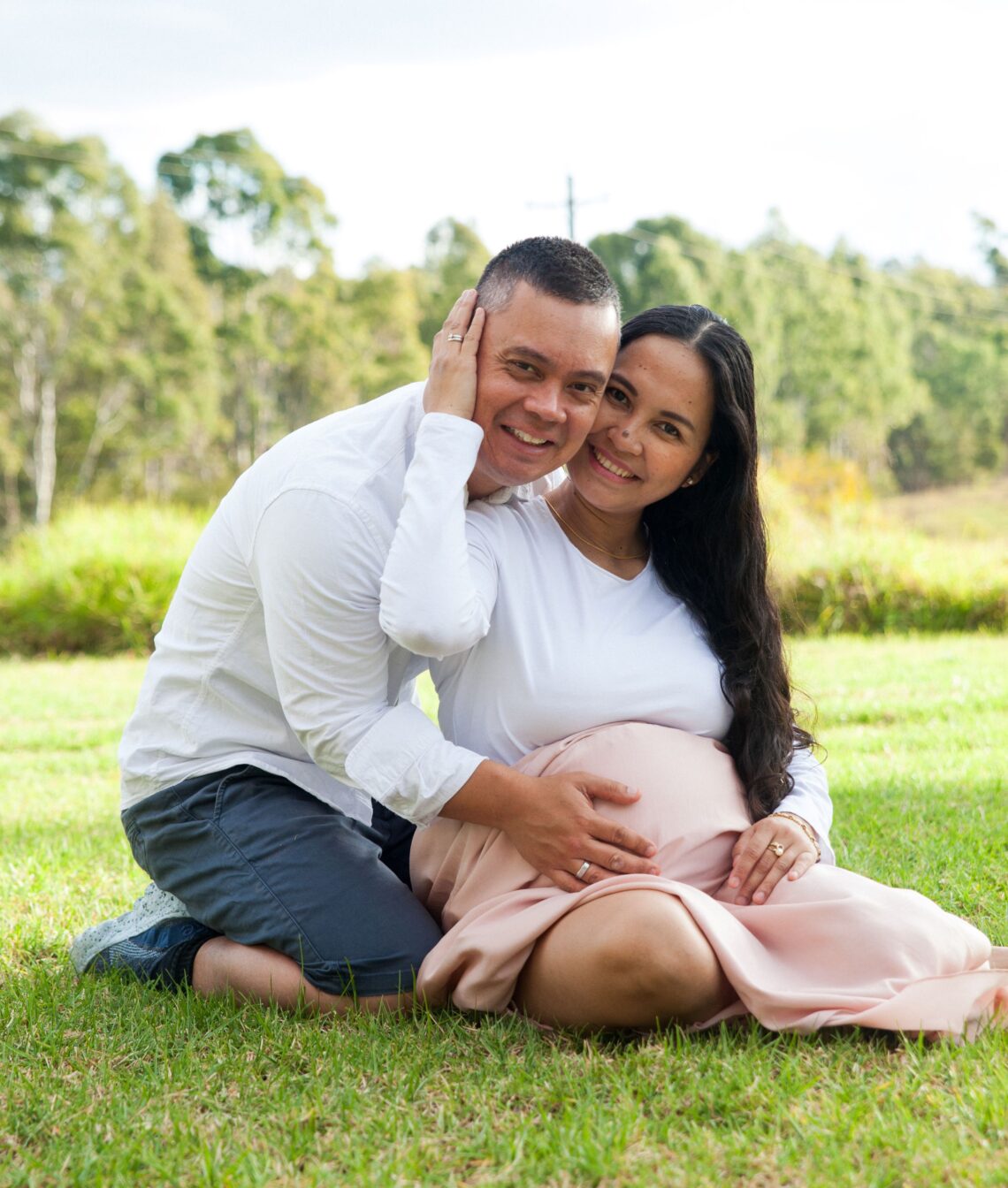 A photo of a couple embracing each other while holding the womb of the pregnant wife/mother
