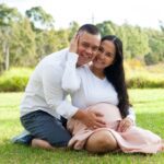 How Jean Found True Love on a Plane: 7 Lessons for a Happy Marriage A photo of a couple embracing each other while holding the womb of the pregnant wife/mother