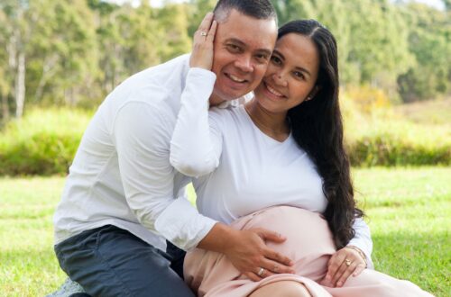 A photo of a couple embracing each other while holding the womb of the pregnant wife/mother