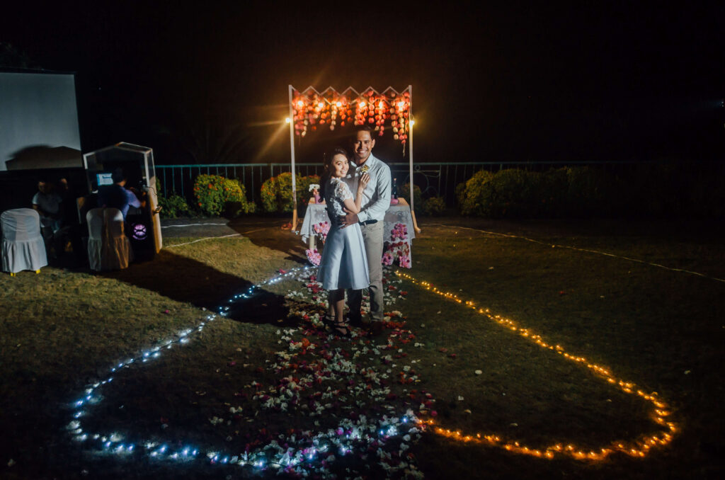 This is such a DIY wedding: Jan Ray designed the arch and assembled the light bulbs from scratch. I made the paper flowers as adornments.