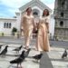 Faith Ido-Barrete and Margelyn Moncano-Cañon walking hand in hand in front of a church in Tagbilaran City, Bohol.
