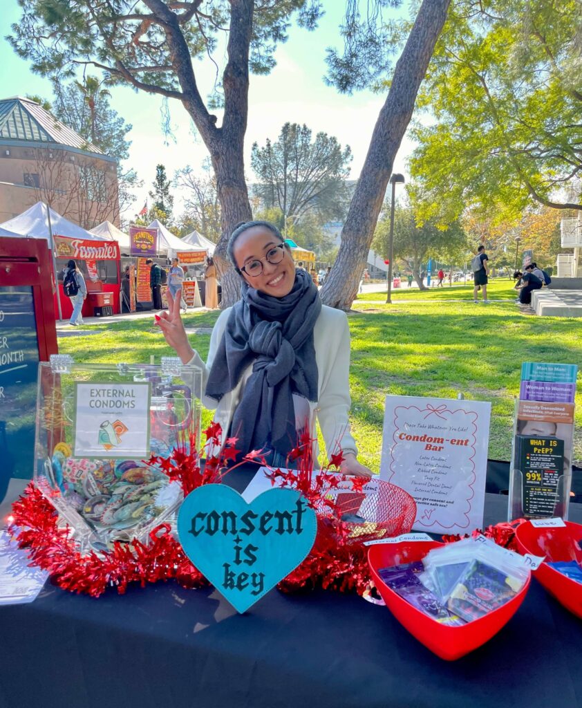 Dr. Kathleen Besas at a campus sexual health awareness booth promoting consent education.