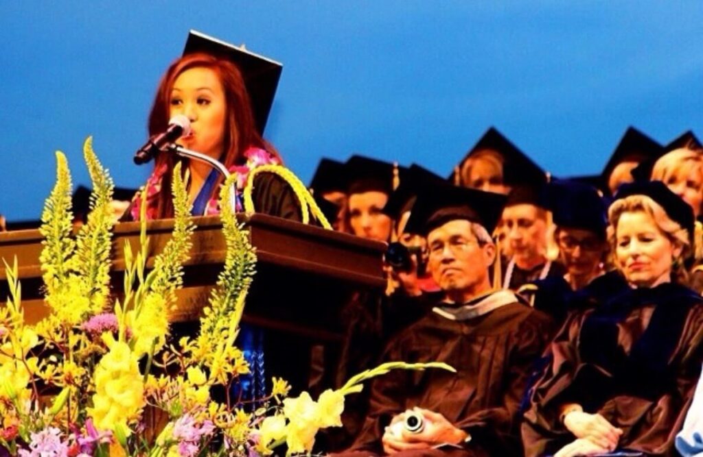 Dr. Kathleen Besas delivering a keynote speech at her UCLA nursing graduation ceremony.
